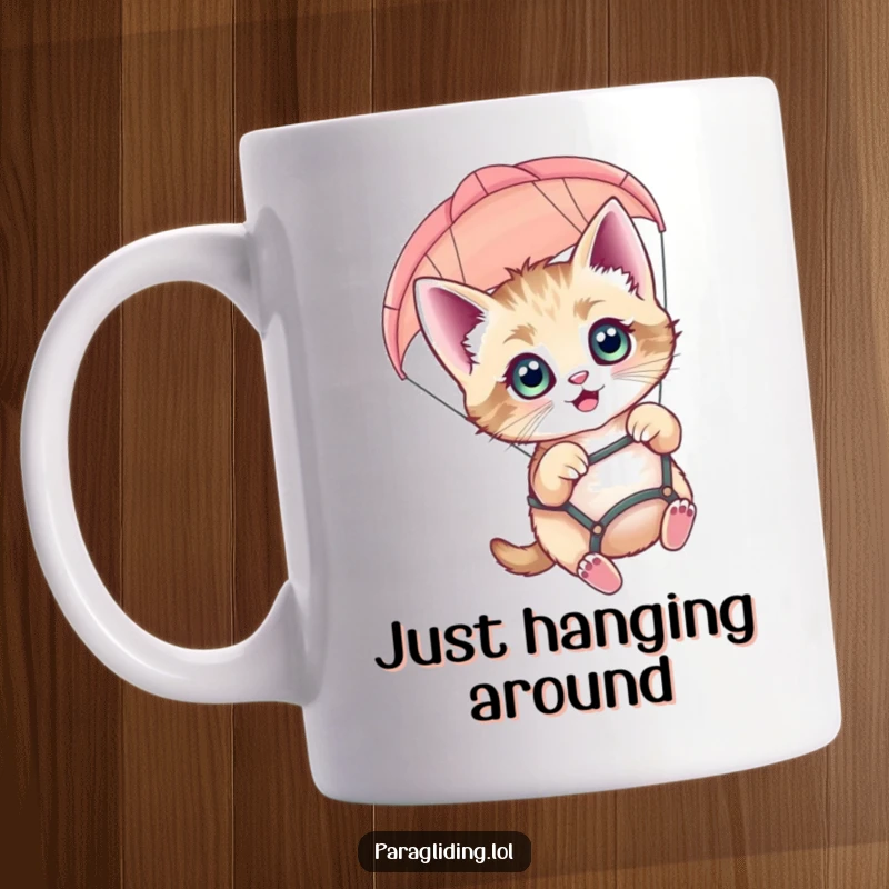 Funny kitten mug with wide eyes joyfully paragliding, looking down from above with excitement and wonder.