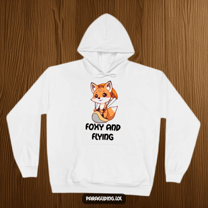 Cozy funny hoodie featuring a determined fox paragliding, offering warmth and a spirit of adventure.