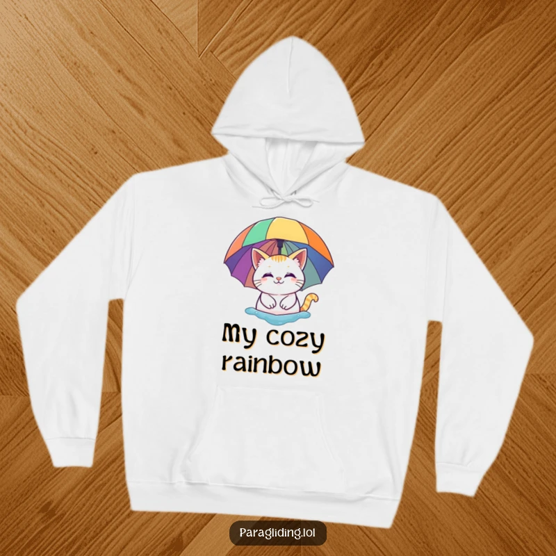 Funny hoodie: A smiling cat peacefully floating under a vibrant rainbow umbrella. Soft, warm, and humorously delightful.
