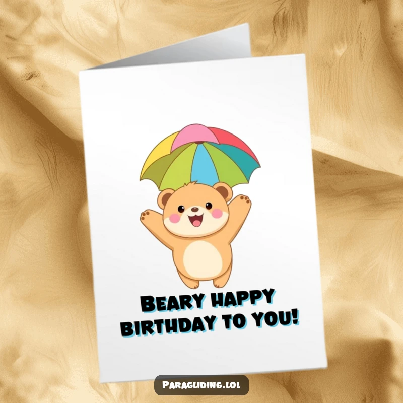 Funny Free Printable Birthday Card: Joyful bear cub soars with colorful canopy, happy DIY greeting, downloadable.