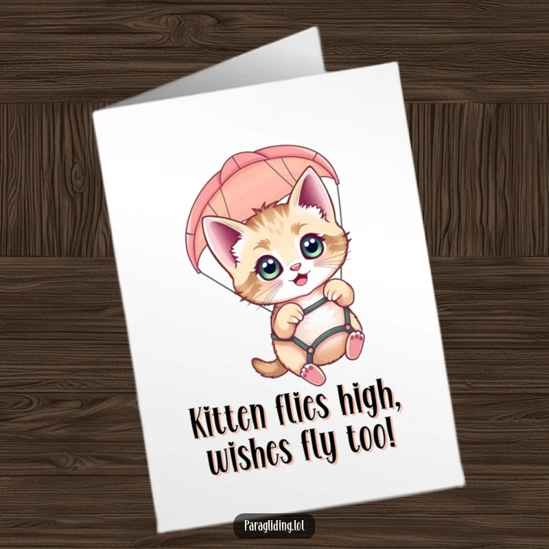 Funny free printable birthday card featuring a wide-eyed kitten joyfully paragliding with a smile. Perfect for a cat lover's special day.