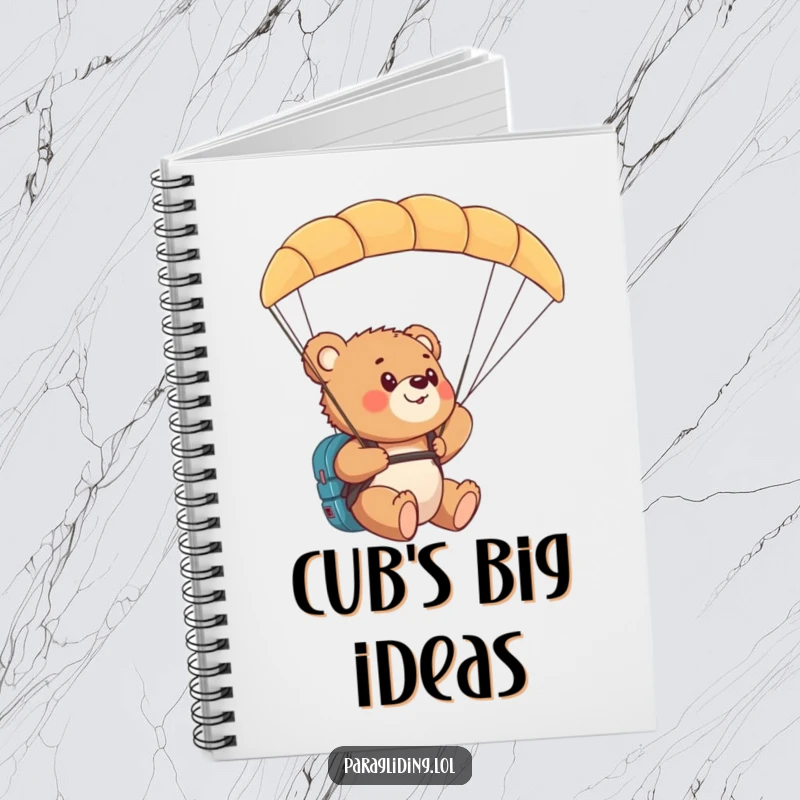 Funny bear cub paragliding notebook with a cub amazed by the aerial view from a paraglider.