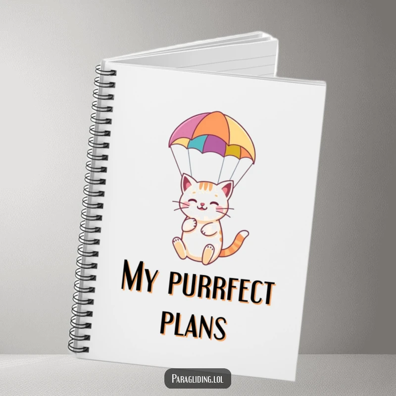 Funny notebook with a happy cat serenely paragliding under a colorful paraglider, ideal for calm notes.