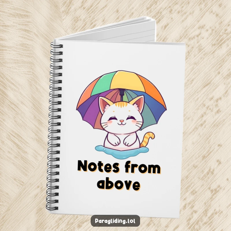 Funny notebook: A smiling cat floating peacefully under a vibrant rainbow umbrella. Ideal for journaling, sketching, and dreaming.