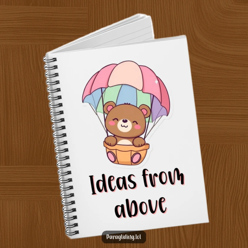Funny notebook cover with a happy bear floating peacefully in a colorful parachute, perfect for jotting down calm thoughts, ideal funny gift.