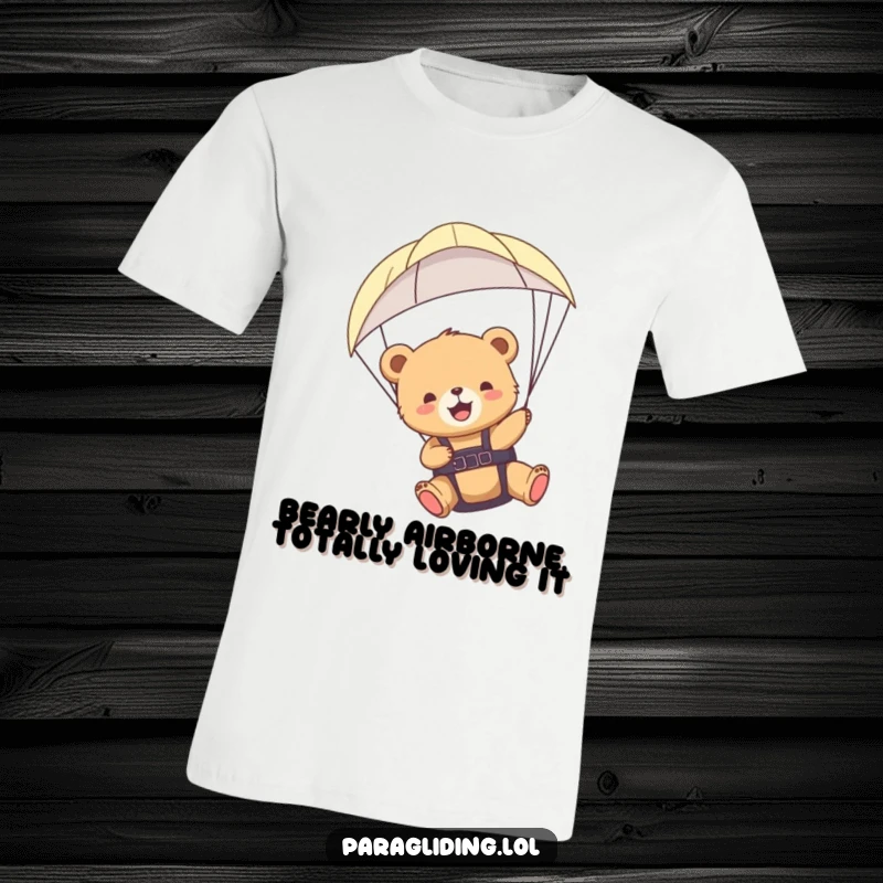 Funny paragliding bear cub t-shirt, capturing a moment of sheer delight and freedom high above the clouds.