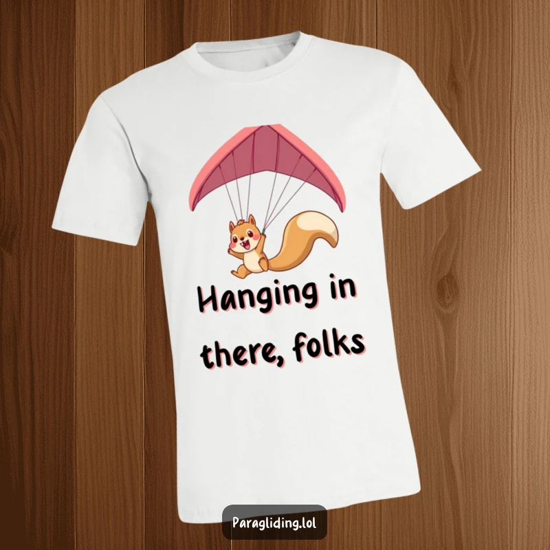 Funny squirrel paragliding t-shirt featuring an excited squirrel dangling precariously, a humorous depiction of adventure.