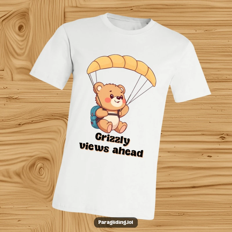 Funny bear cub paragliding t-shirt showing a cub amazed by the aerial view from a paraglider.